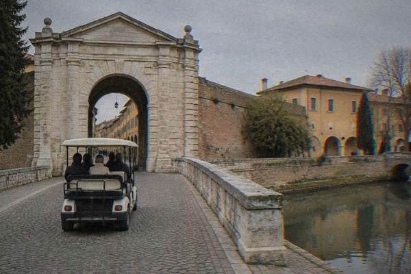 Open golf cart on a cobbled lane in an old town