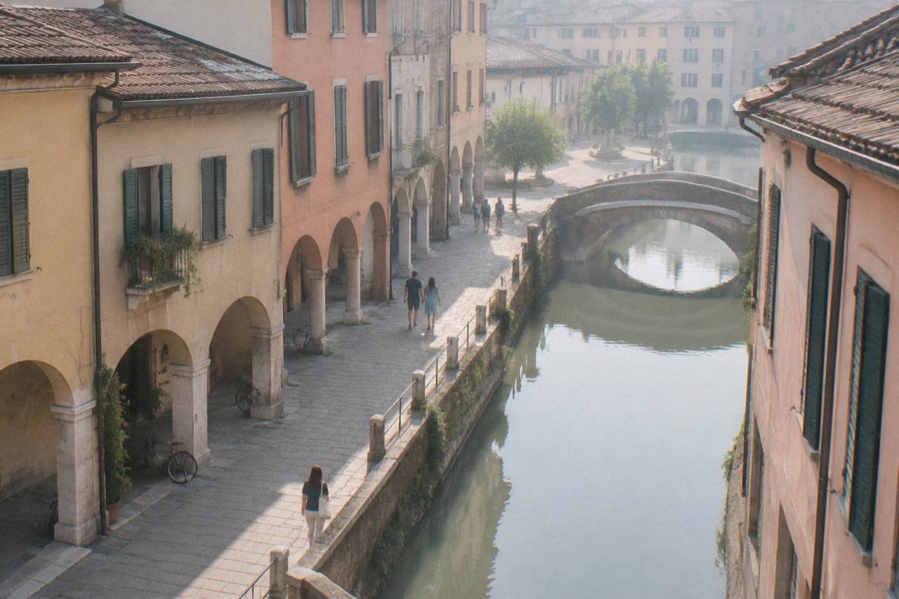 An Italian street sign reading Padova on a stone wall in an arcaded street in Padua