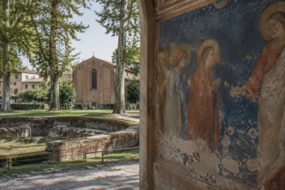 Detail of Giotto frescoes showing figures against a blue background inside the Scrovegni Chapel
