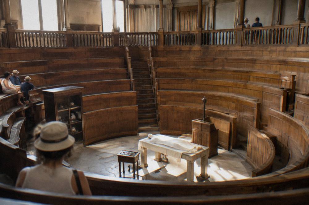 Interior of the wooden anatomical theatre at the University of Padua, with tiered galleries rising above the dissecting table