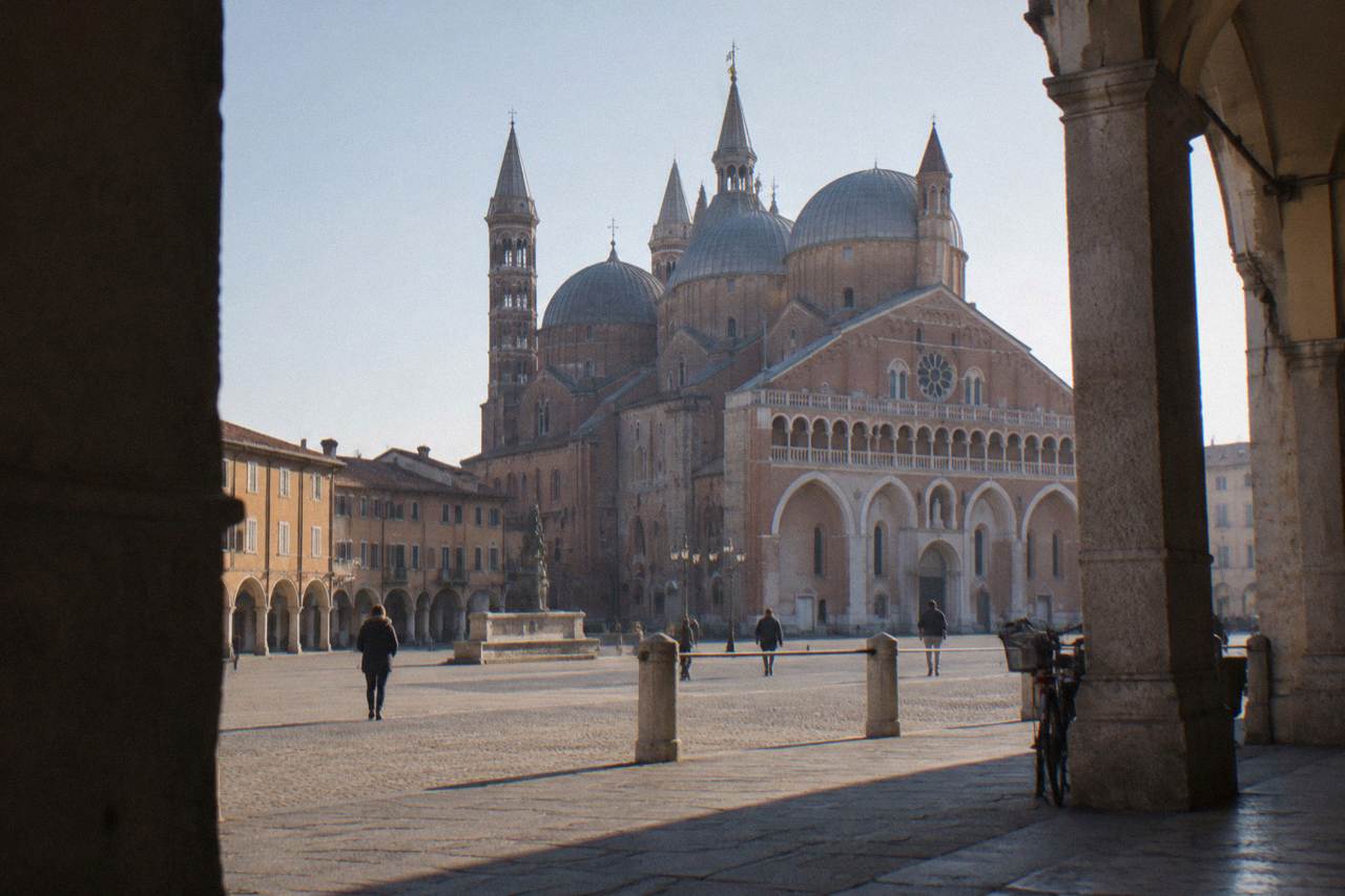 The brick facade and domes of the Basilica of Saint Anthony in Padua seen from the square