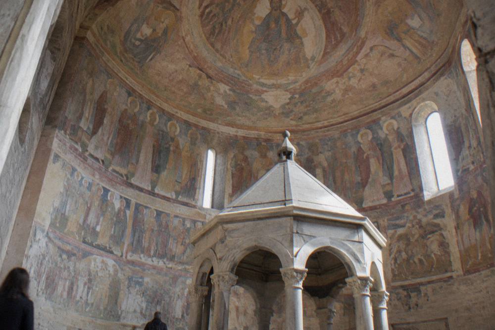 Interior of the Padua Baptistery with Menabuoi frescoes covering the walls below a painted dome