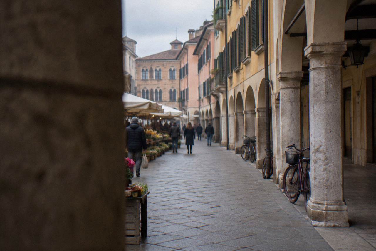 Arcaded historic street in Padua with market stalls and old palace facades