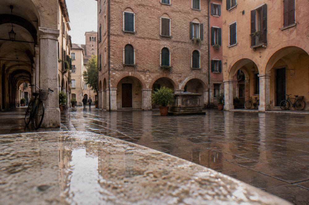 A small quiet square in Padua enclosed by old brick apartment buildings