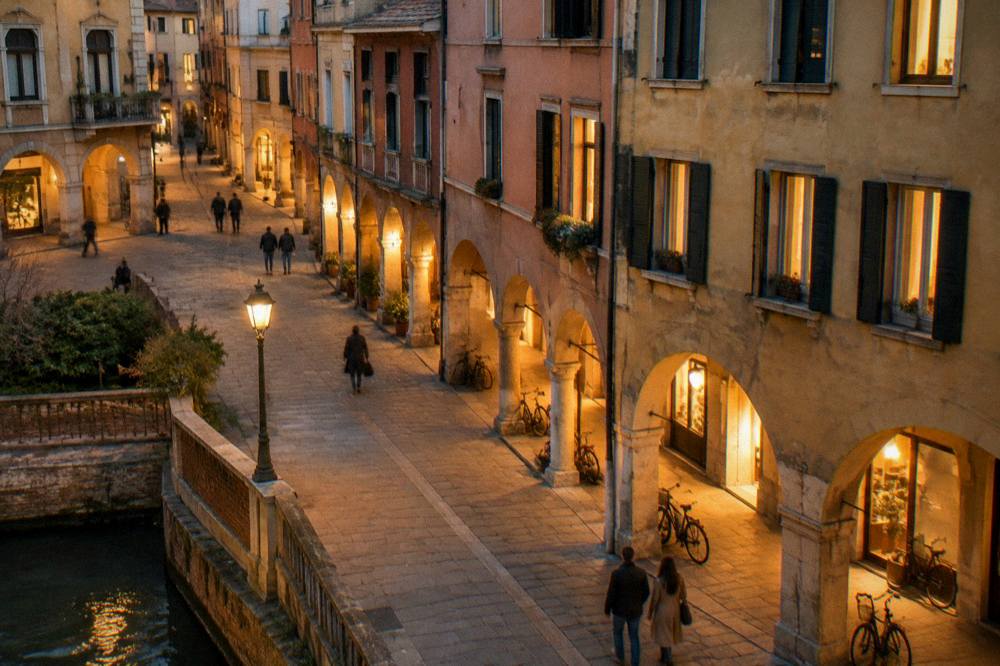 An evening street scene in Padua with lit windows over an arcade
