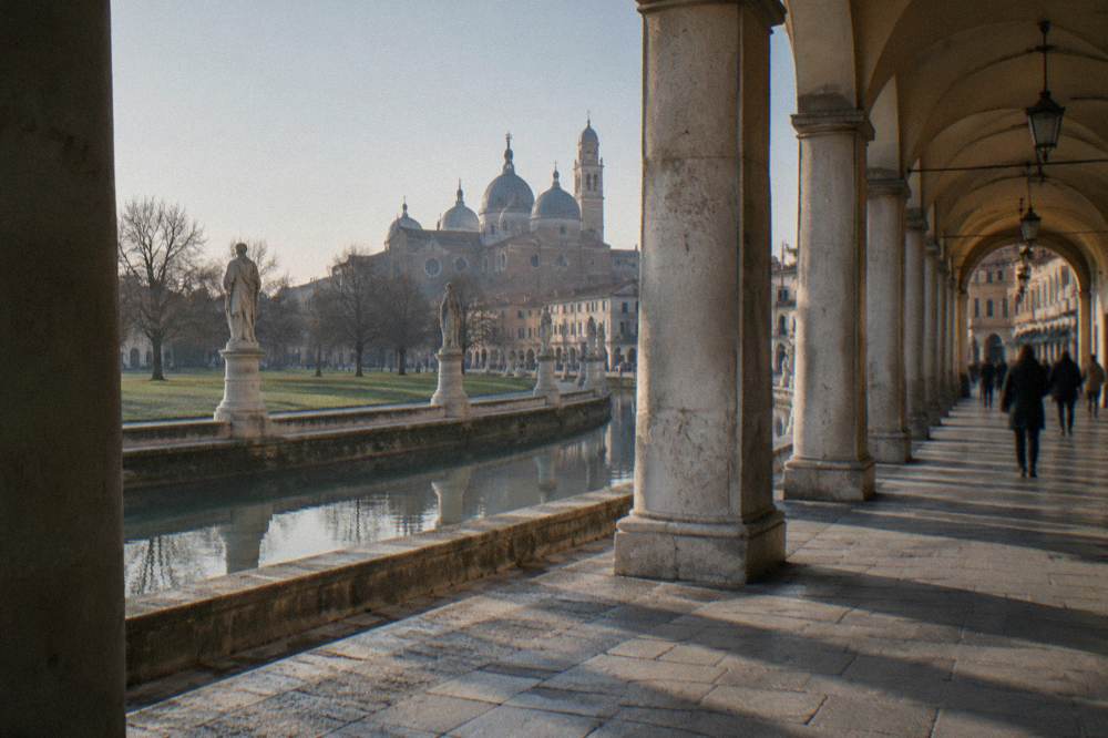 A colonnaded street leading toward the domes of the Basilica of Saint Anthony in Padua