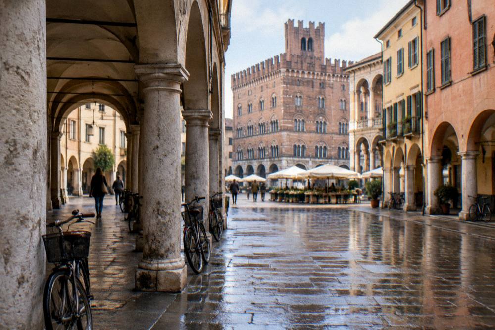An arcaded street in Padua with market squares and a historic palace beyond