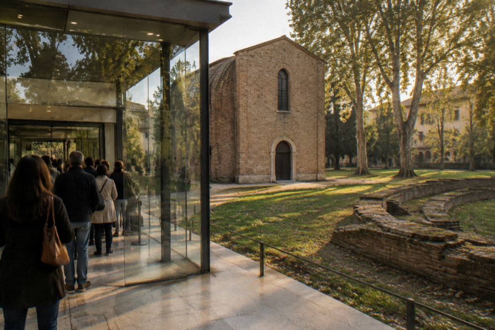 Visitors waiting in a modern glass-walled reception room before entering a historic chapel