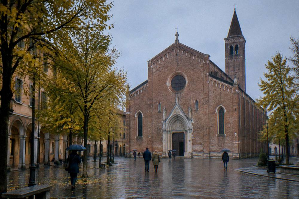 Rainy day light falling on the brick facade of the Eremitani Church seen from the square in Padua