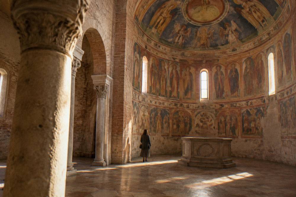 The interior of the Padua Baptistery with frescoed walls rising to a painted dome