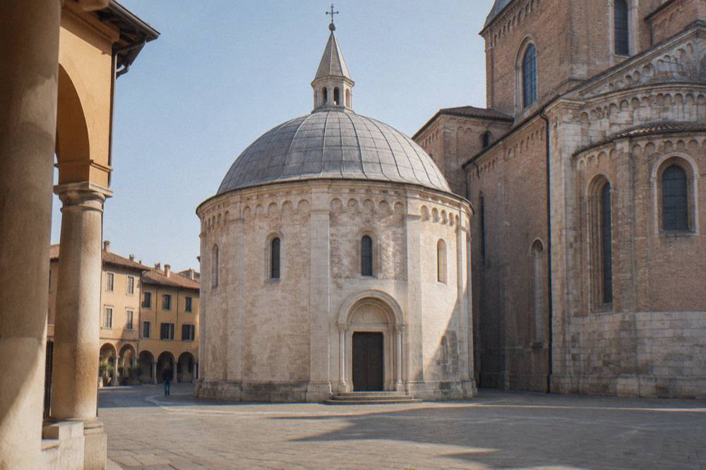 The exterior of the Padua Baptistery with its stone dome and simple facade