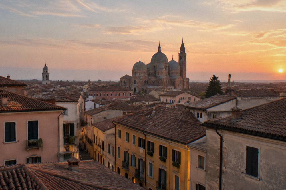A view across central Padua rooftops toward the dome of the cathedral at dusk