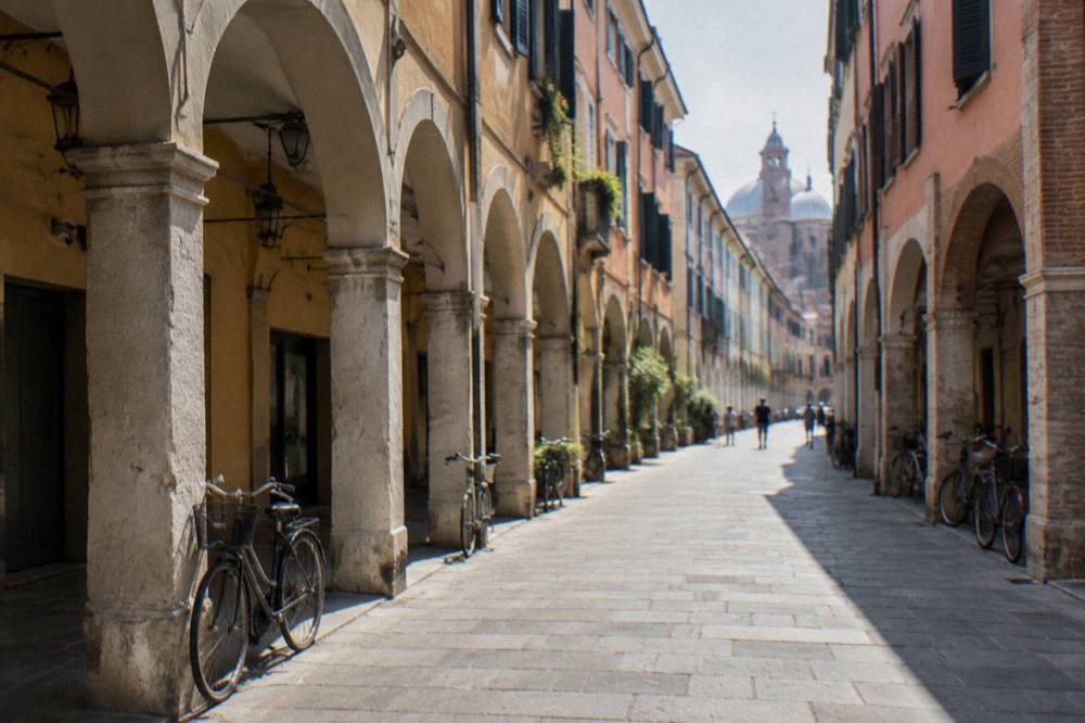 An arcaded Padua street with bicycles parked against old buildings