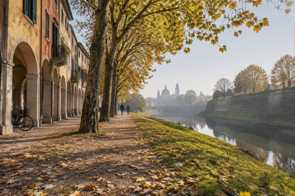 Bastion grass banks of the Padua walls in autumn with fallen leaves on the path