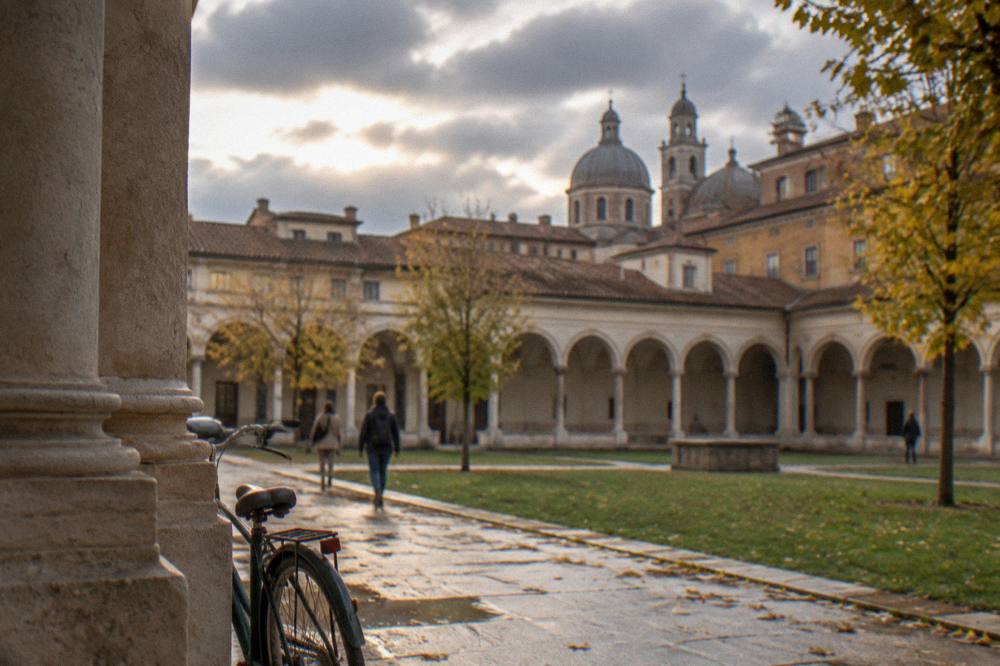 Autumn rain clouds over rooftops and domes of an Italian city