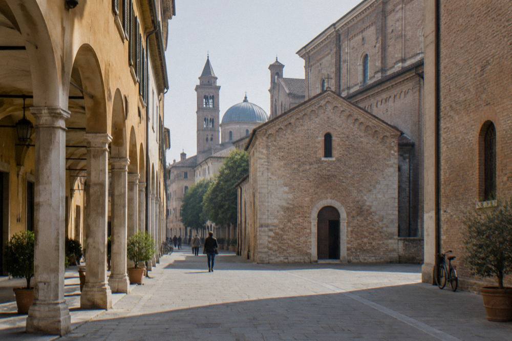 Arcaded street leading toward church towers in central Padua