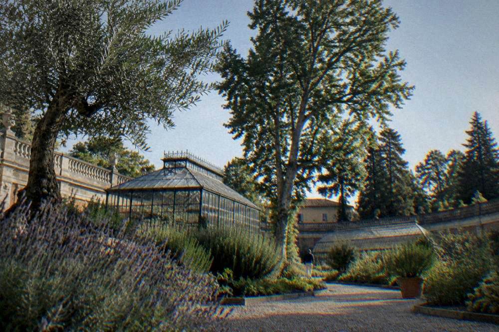 Walled botanical garden with gravel paths and clipped beds