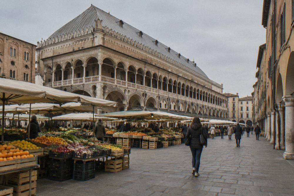 Market stalls with fruit and vegetables in the Piazza delle Erbe beside the Palazzo della Ragione