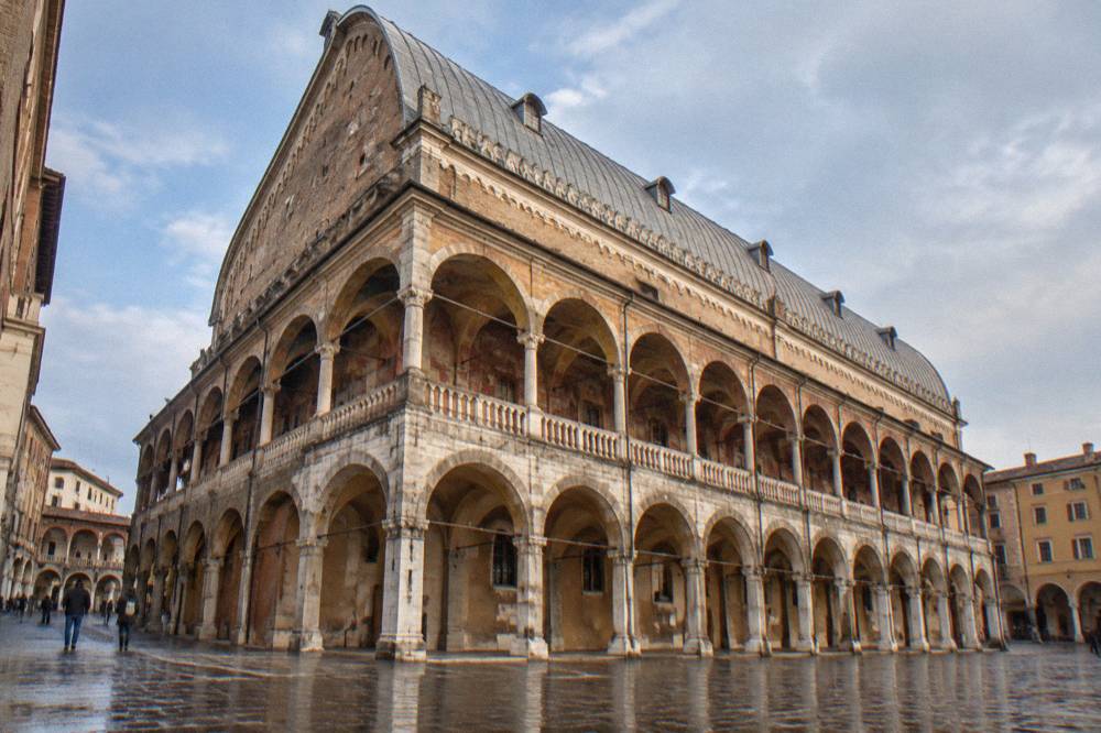 The painted upper walls and giant horse-shoe shaped roof beam inside the Salone of the Palazzo della Ragione