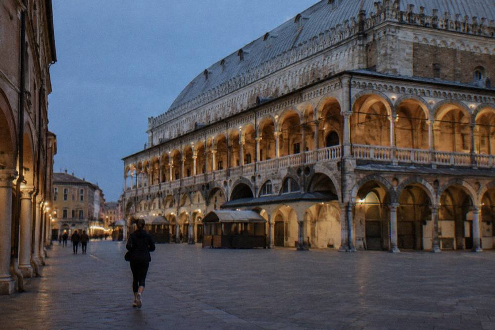 Evening light on the frescoed facade and loggia of the Palazzo della Ragione in Padua