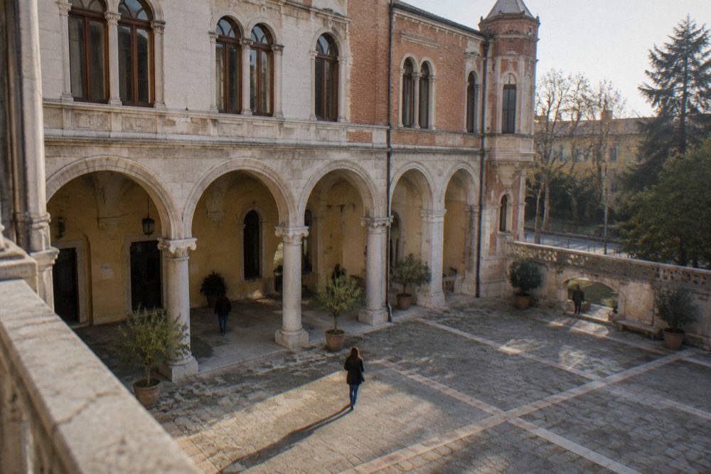 The interior courtyard of a Paduan museum with stone arches and afternoon light