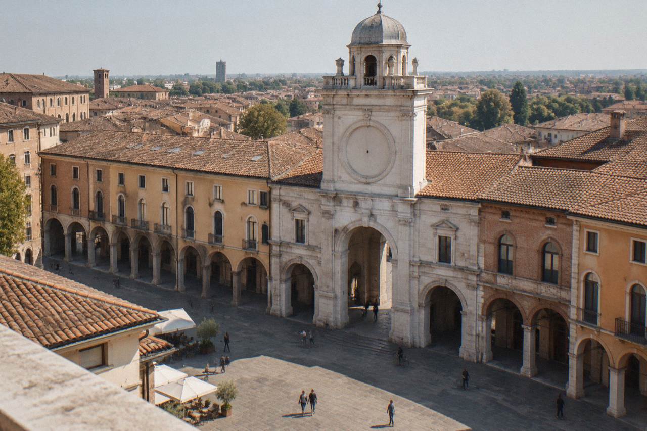 A stone clock tower rising above the rooftops of a Paduan square