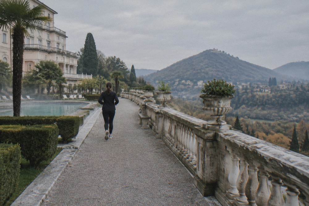 Terraced Renaissance garden with stone balustrade overlooking wooded hills
