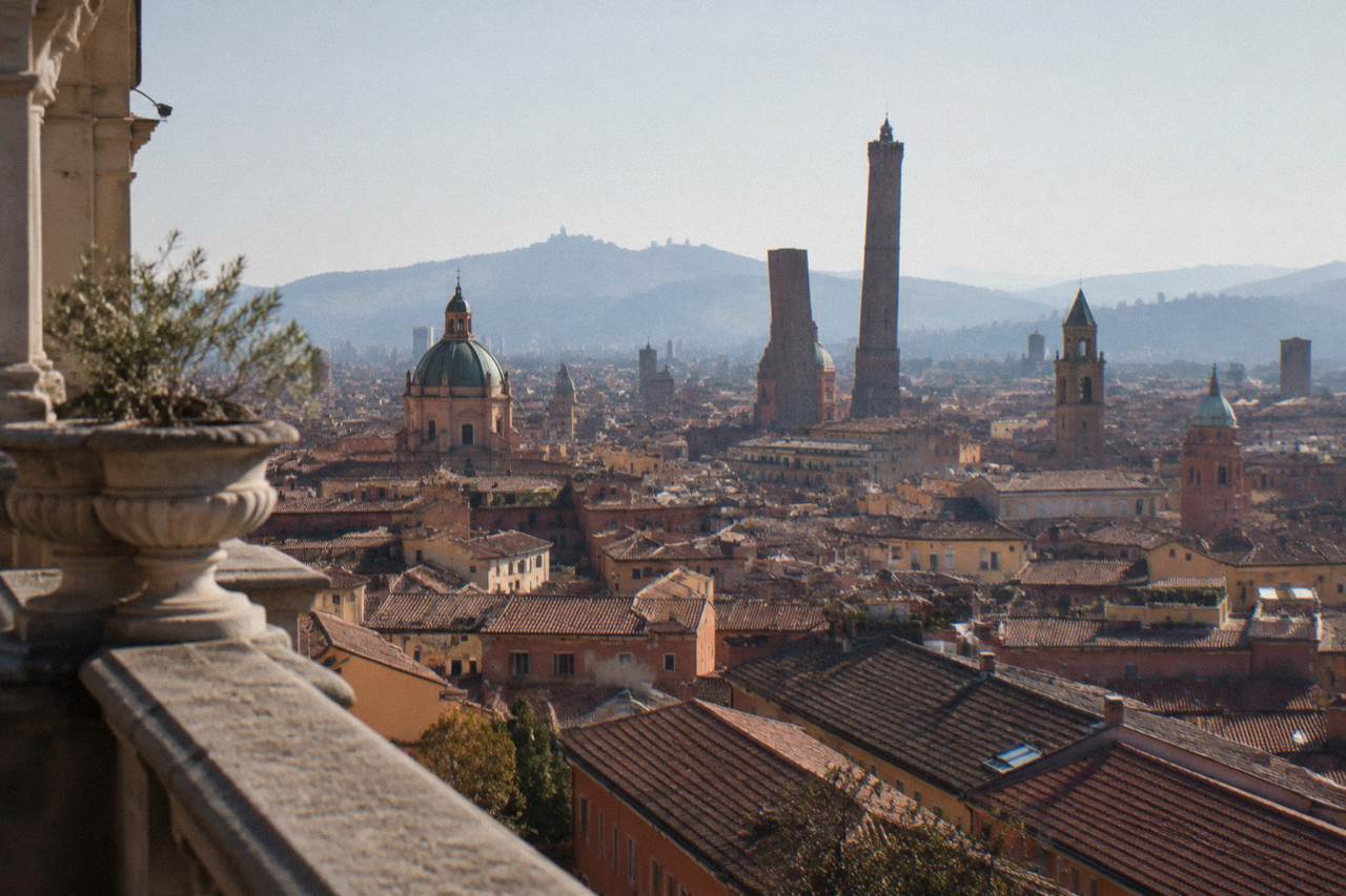 View over Bologna's red rooftops and towers from a high terrace on a clear day