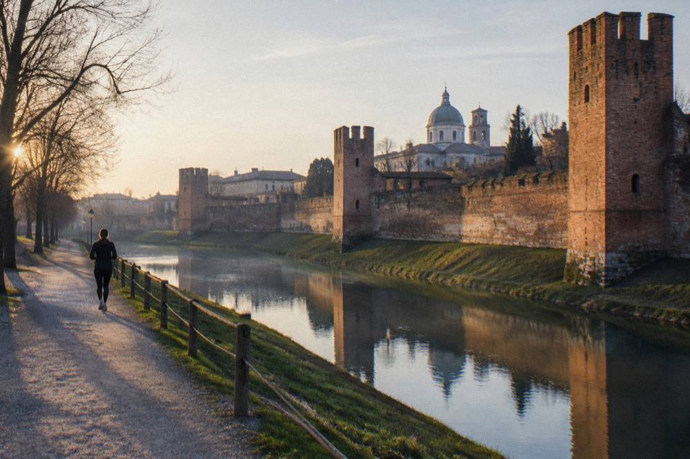 Evening light on old brick walls and towers of a small walled Veneto town