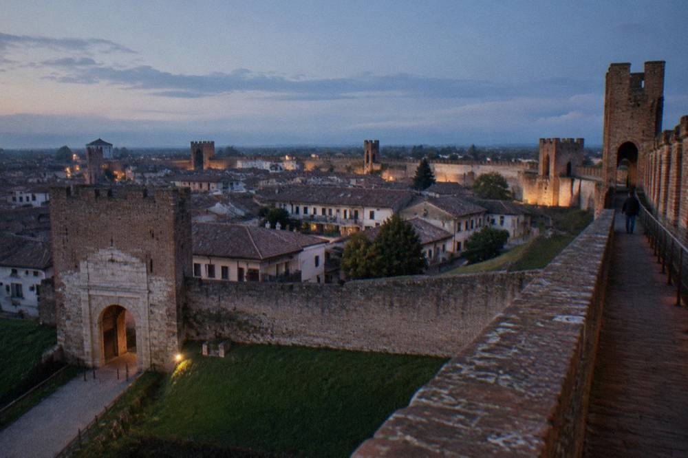 Walkway along the top of a medieval wall looking over rooftops