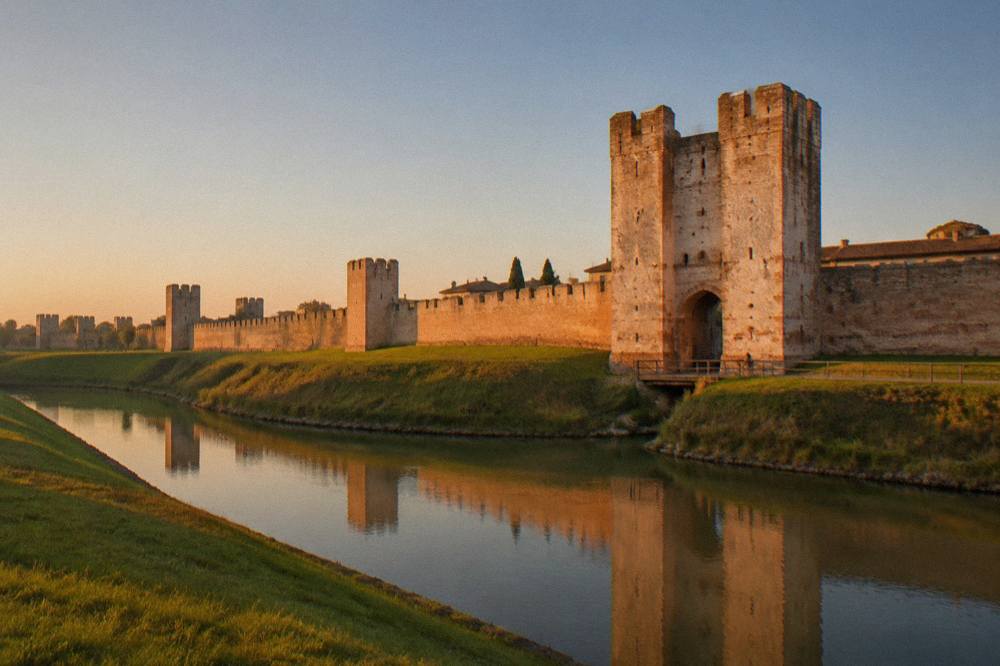 A stone gate tower of Montagnana at golden hour with clear sky