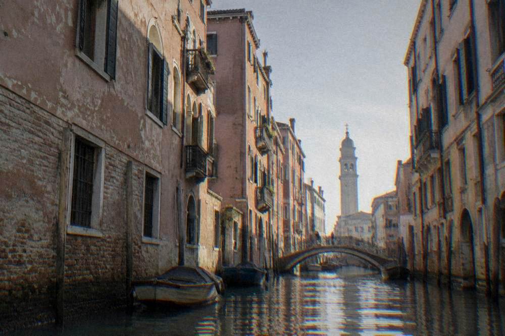 Canal lined with old brick buildings and a small bridge