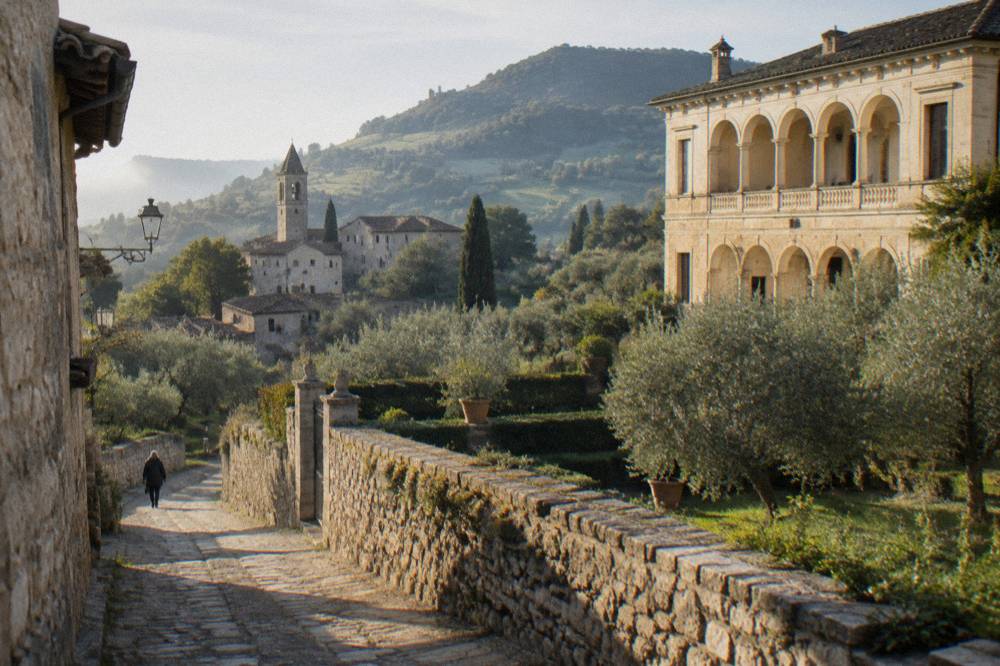 A Renaissance villa facade with symmetrical arches above gardens in the Euganean hills
