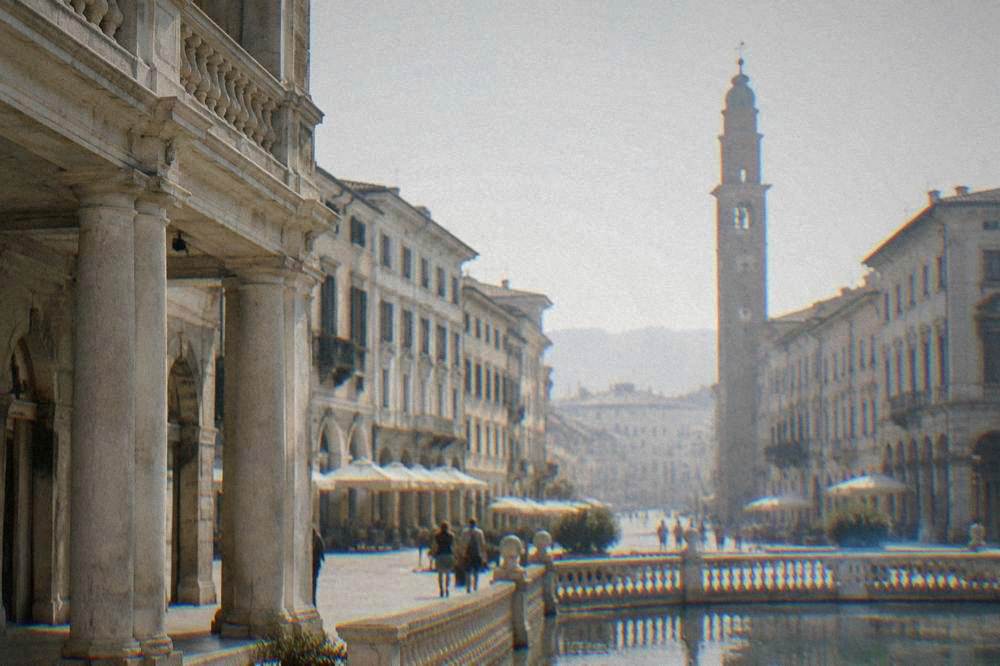 Pale stone palace with a classical arcade on a city square