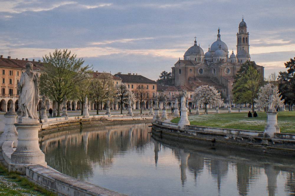 Prato della Valle in Padua with its canal ring and statue-lined square in spring light