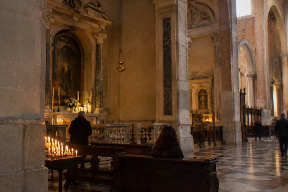 The interior of the Basilica of Saint Anthony in Padua with the tomb of Saint Anthony and worshippers nearby
