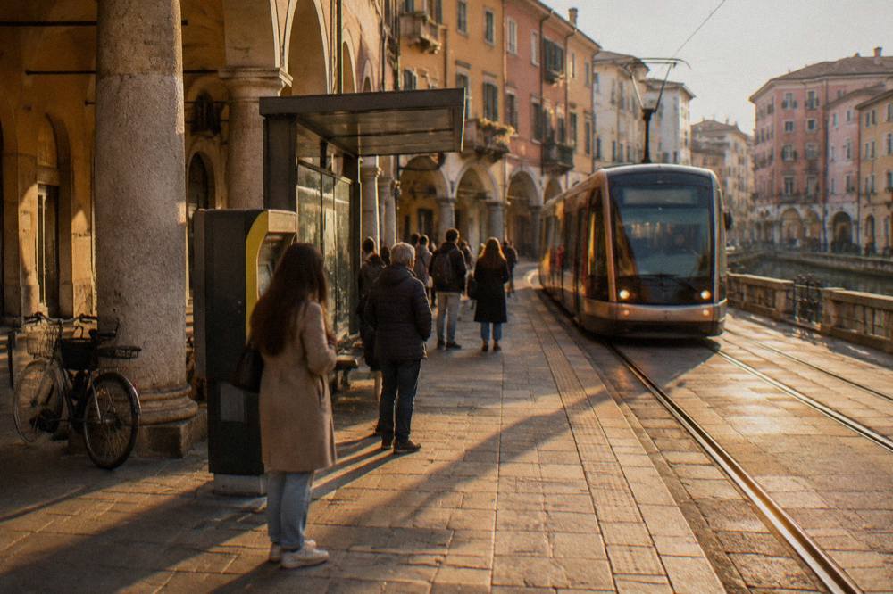 A tram stop in Padua with a ticket machine and people waiting