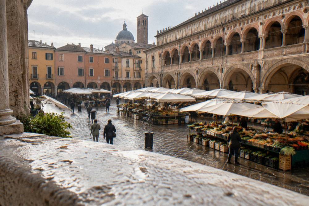 Arcaded streets and a market square in the historic centre of Padua seen from above