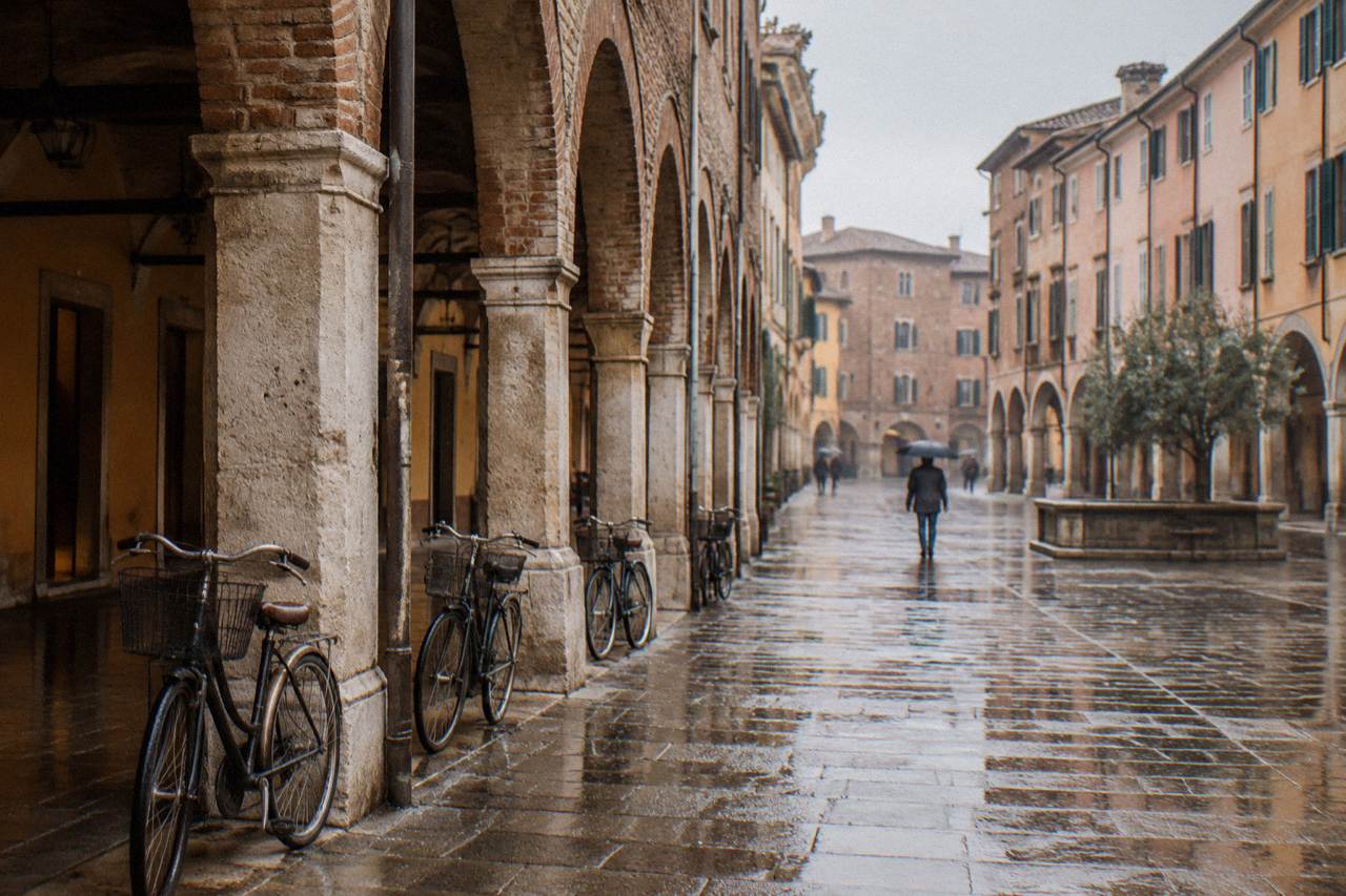 Arcaded streets and old brick facades in the centre of Padua under a soft sky