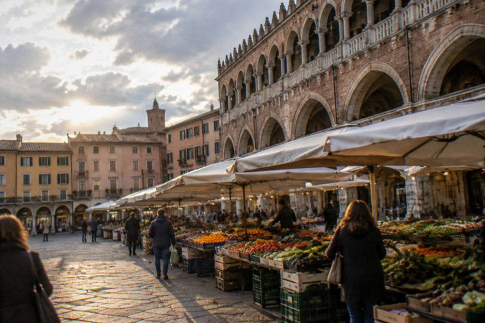 Evening light on Piazza delle Erbe with the market stalls and arcades of Padua