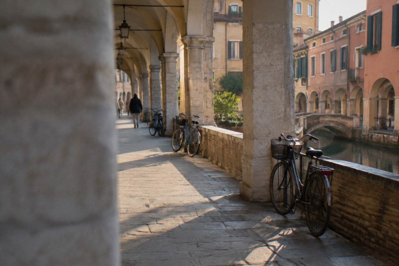 Bicycles parked beside an arcaded street in the centre of Padua