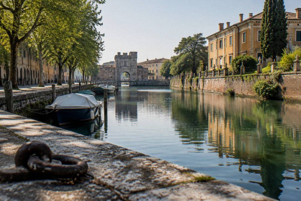 A riverside villa with lawns facing calm water along the Brenta