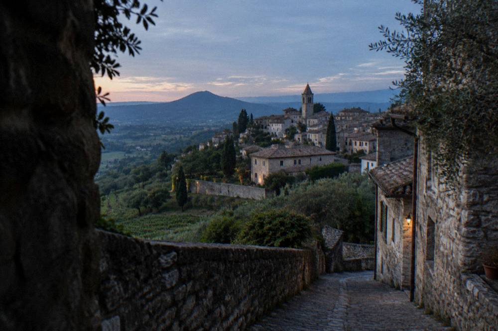 A stone villa with a walled garden on a hillside above vineyards near Padua