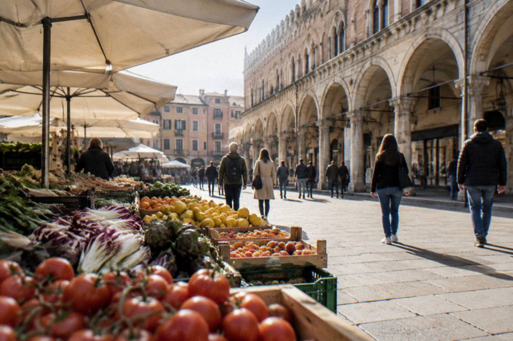 People walking under medieval arcades near Piazza delle Erbe in Padua