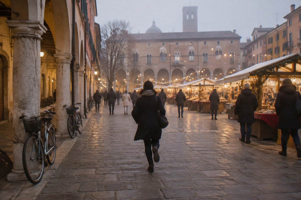 Festive market stalls and string lights in a Padua square at dusk, with arcaded buildings behind