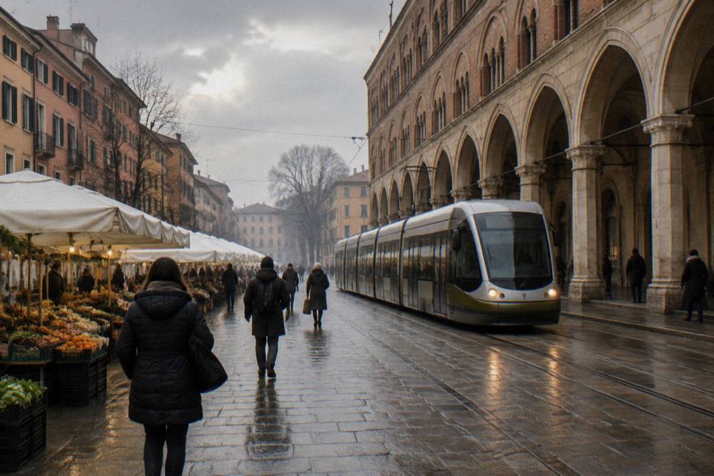 A modern tram passing arcaded buildings on a city street in winter light
