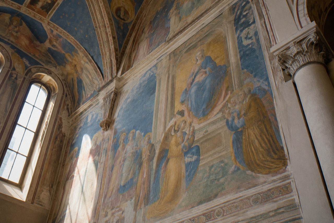 Frescoed interior wall of a Padua church with figures in blue and gold