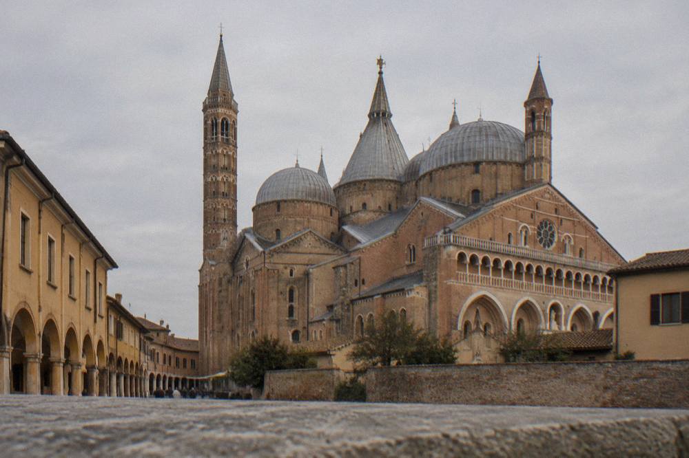 Exterior of the Basilica of Saint Anthony in Padua with brick towers and domes