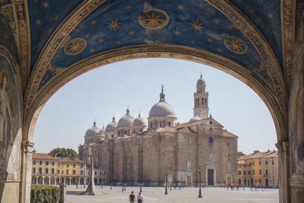 Blue vaulted ceiling of a small frescoed chapel with star medallions
