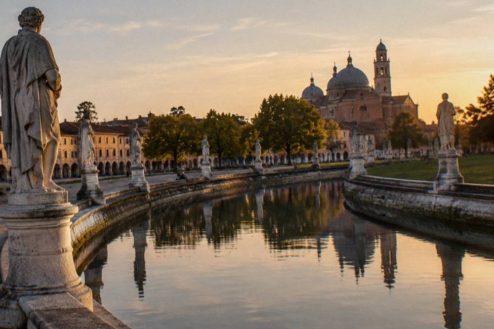 Evening light on the statues and canal of Prato della Valle in Padua